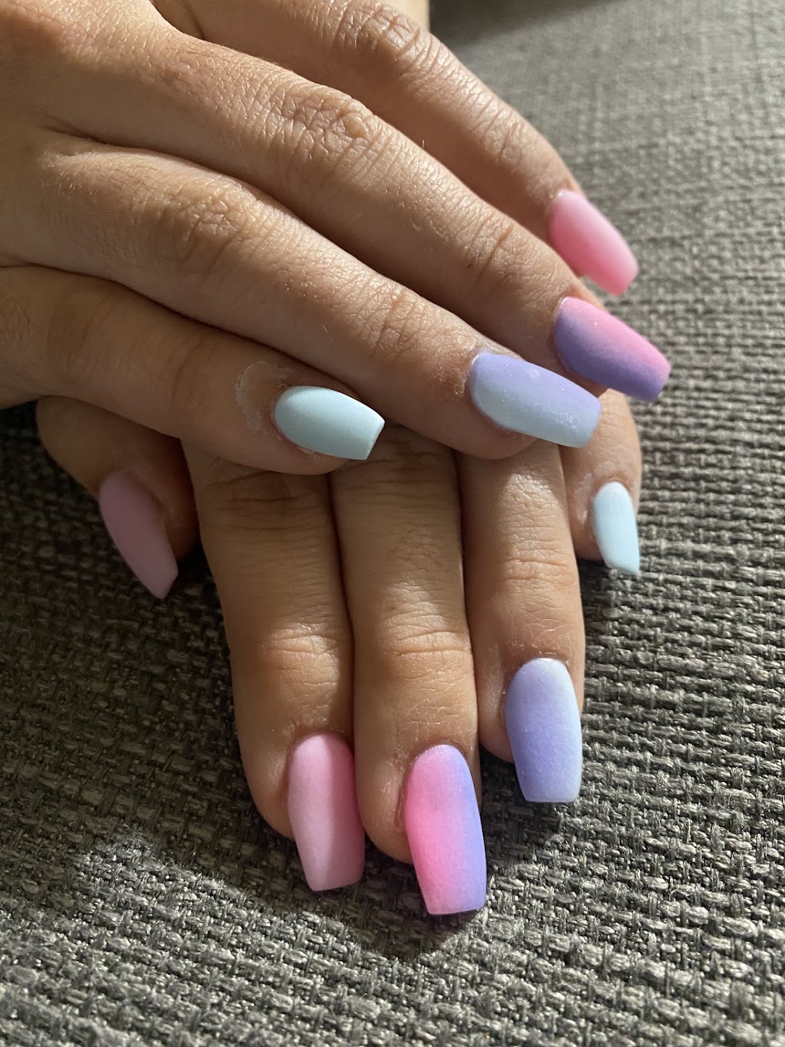 Hands with a pastel ombre coffin shaped set, photographed at the salon